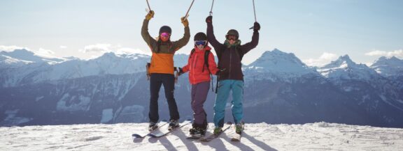 sportgardena-celebrating-skiers-standing-snow-covered-mountain