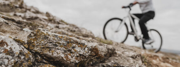 sportgardena-man-riding-mountain-bike-safety-equipment